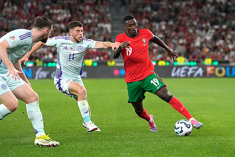 2024–25 UEFA Nations League, Portugal vs Scotland: Portugal's Nuno Mendes, right, and Scotland's Ryan Christie challenge for the ball 